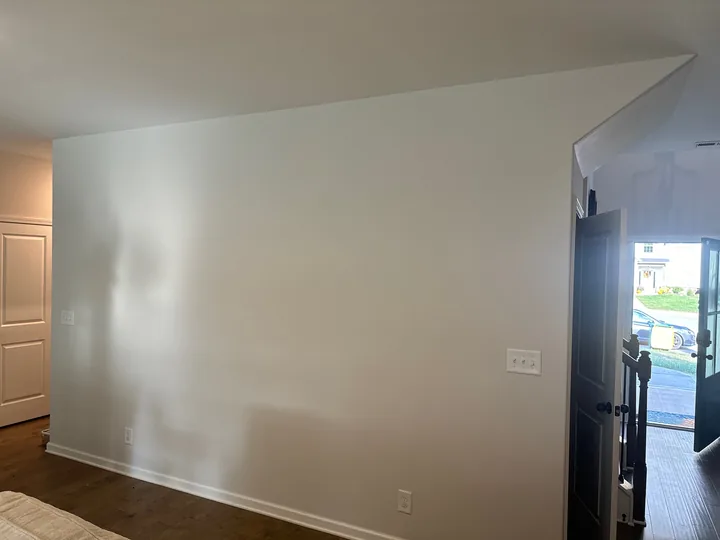 Interior wall shown with orange paint and a light neutral finish