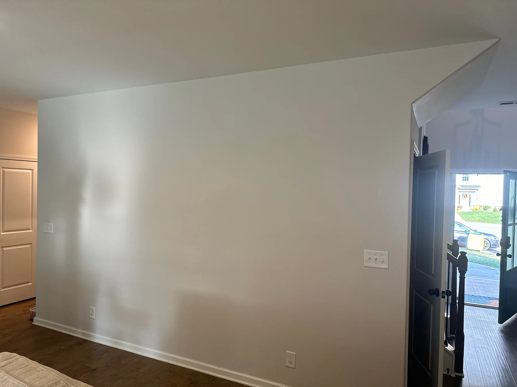 Interior wall shown with orange paint and a light neutral finish