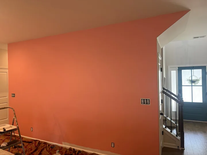 Interior wall shown with orange paint and a light neutral finish
