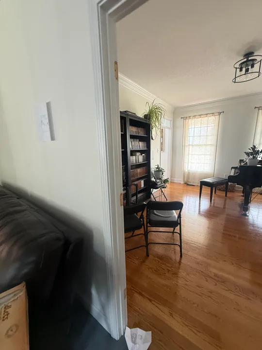 Painted interior wall, white doorway trim and wood flooring