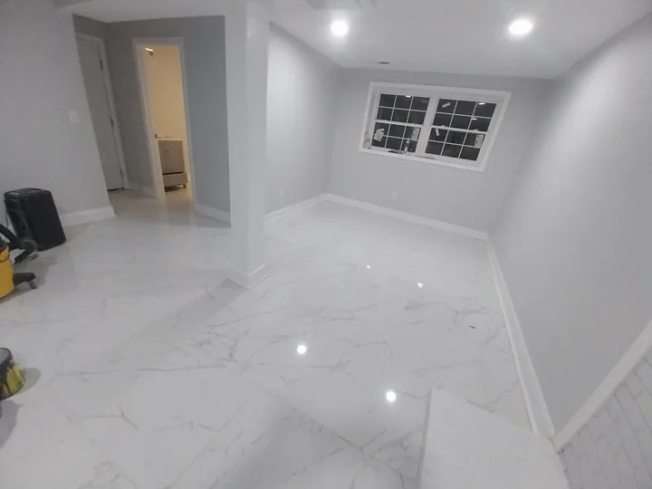Light bathroom with bathtub, tiled shower and shower glass