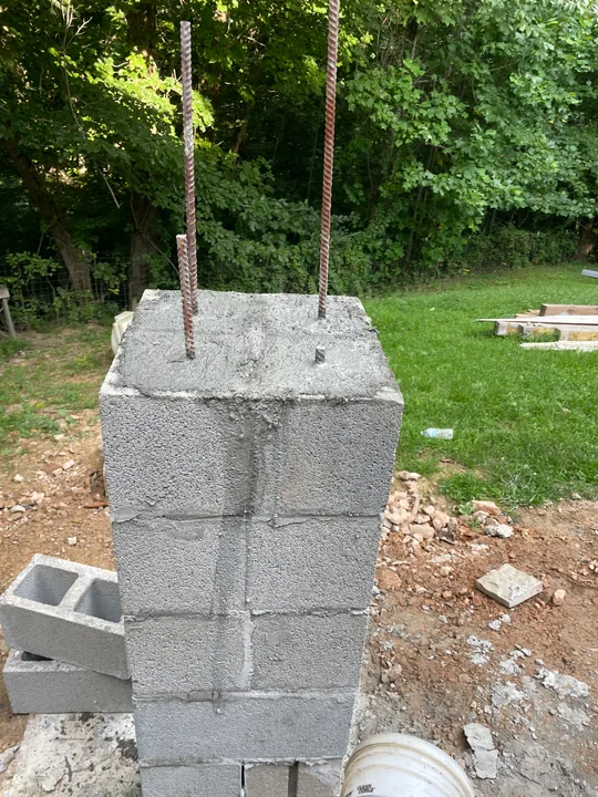 Masonry support piers and concrete formwork beside a home
