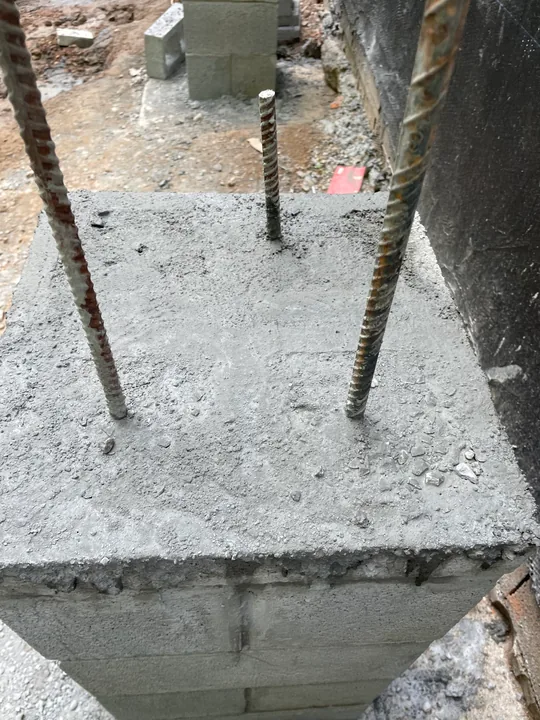 Masonry support piers and concrete formwork beside a home