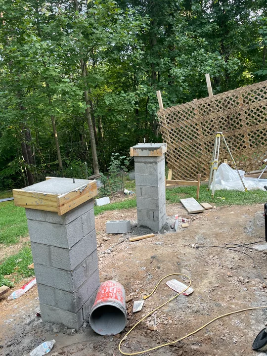Masonry support piers and concrete formwork beside a home