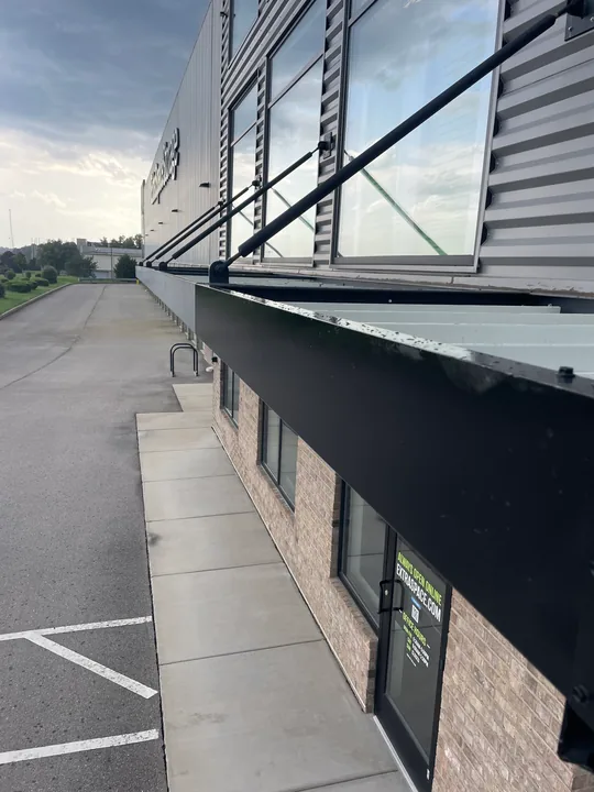 Metal commercial canopy with support frame and connection hardware