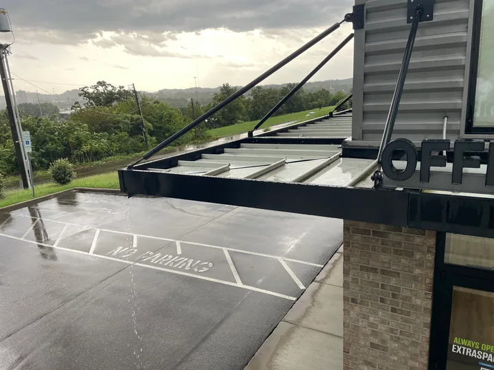 Metal commercial canopy with support frame and connection hardware