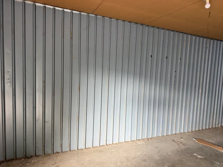 Vertical metal wall panels inside a small commercial room