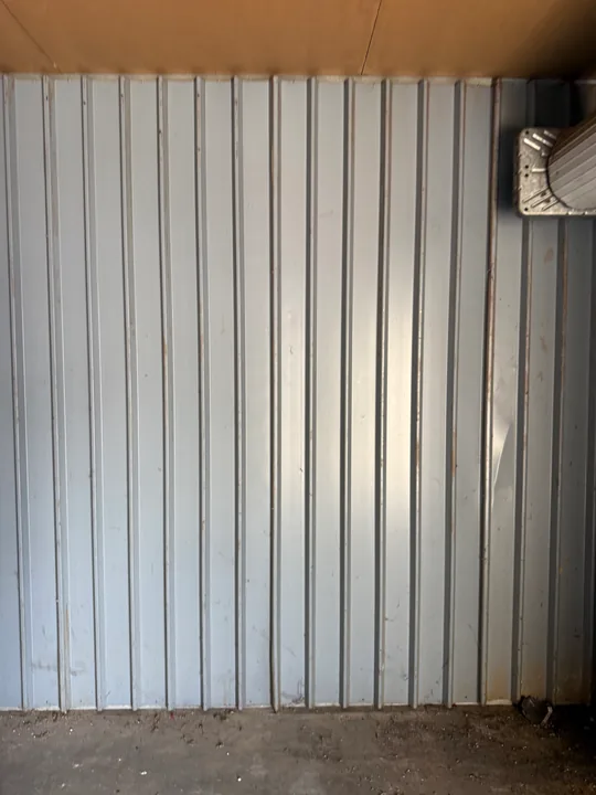 Vertical metal wall panels inside a small commercial room