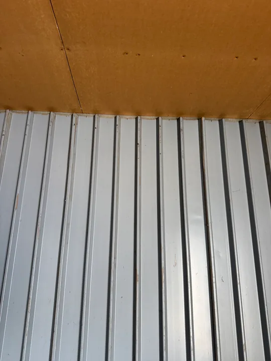 Vertical metal wall panels inside a small commercial room