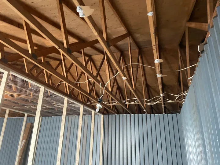 Vertical metal wall panels inside a small commercial room