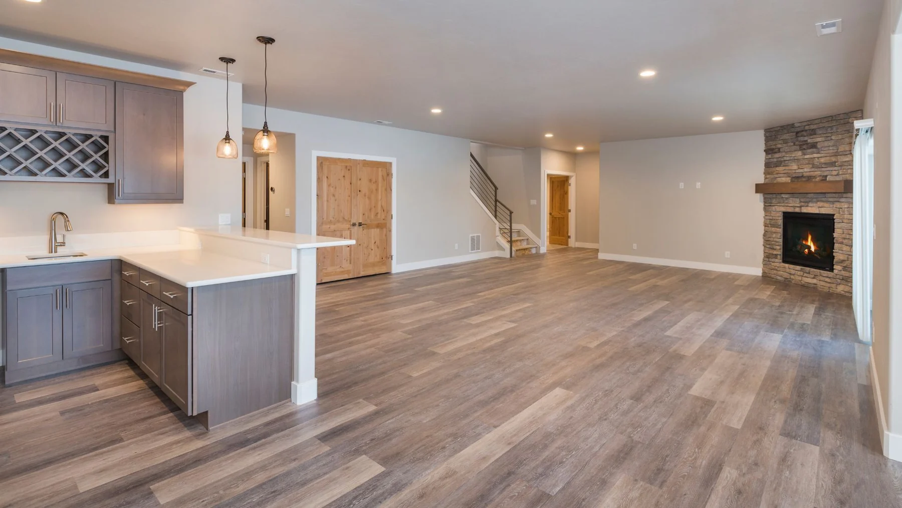 Continuous plank flooring through an open kitchen and living room