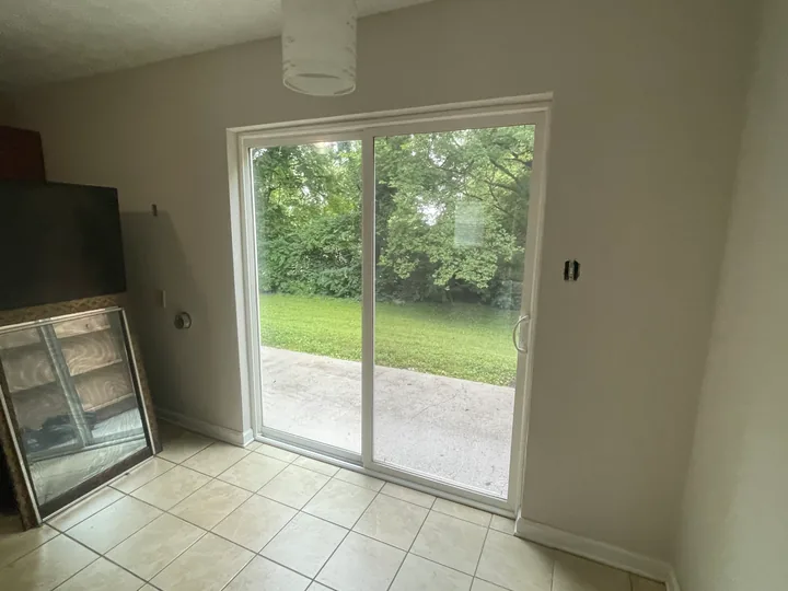 Painted room with white window trim, baseboards and wood flooring