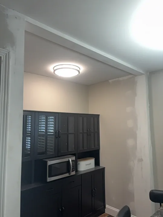 New pantry walls, boxed ceiling edge and ceiling light at the paint-ready stage.