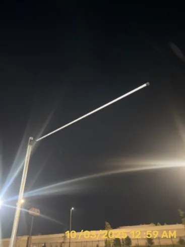 Outdoor light poles illuminating a parking area at night