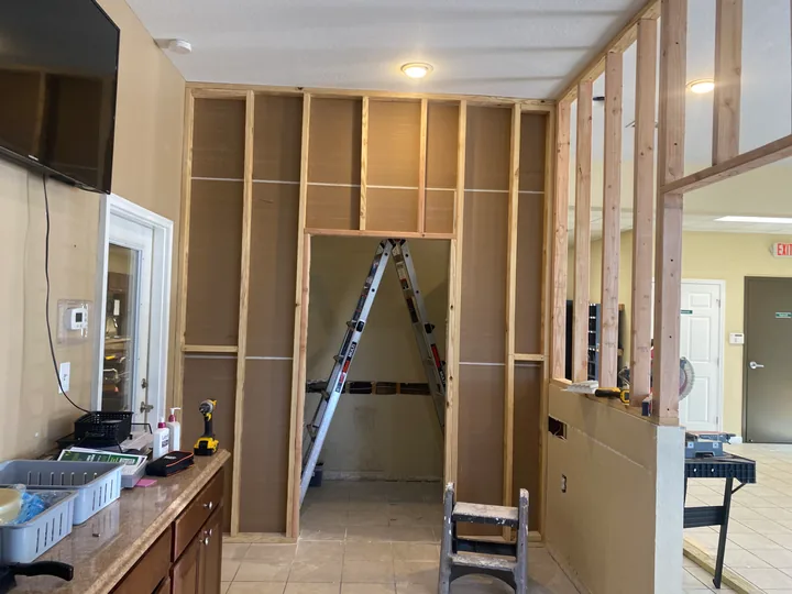 Exposed timber partition framing around a commercial interior doorway