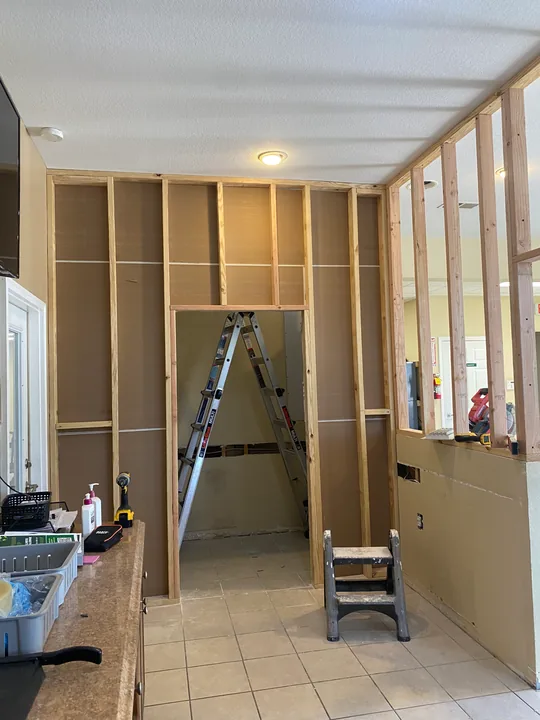 Timber wall framing and an opening beside an existing counter