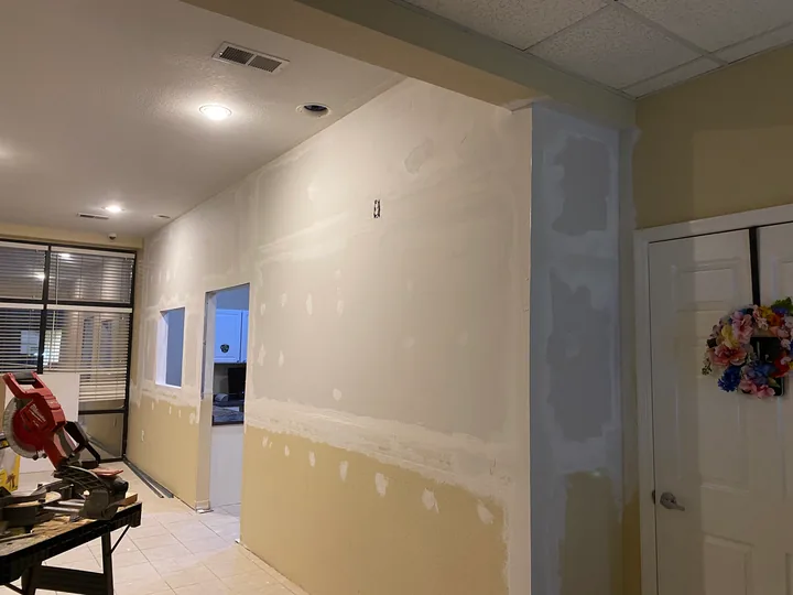 Joint compound on new partition walls beside a hallway