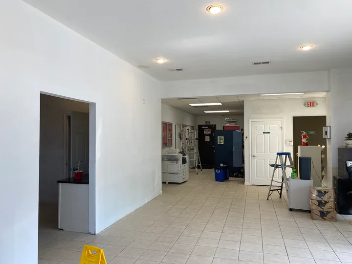 Painted commercial partition with doorways and open floor area