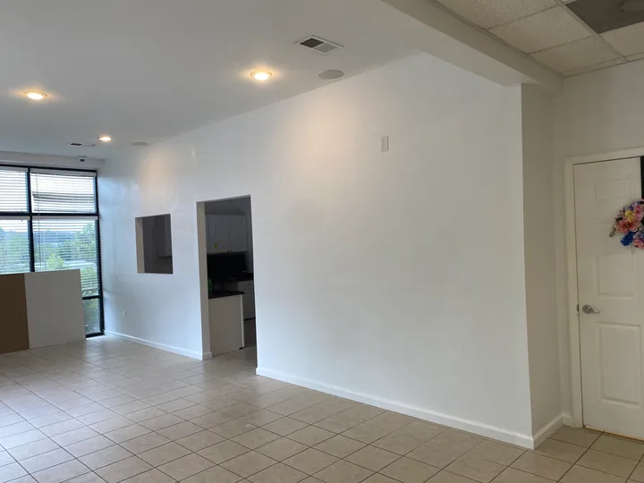 Finished wall surfaces and an interior corridor in a commercial space
