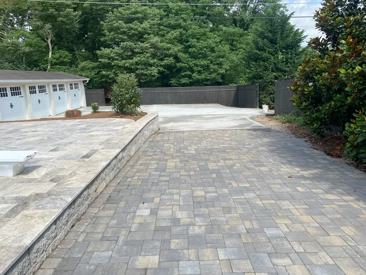 Curved paver driveway and walkway beside a home
