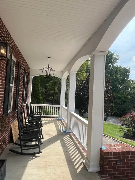 White porch columns, arches and railings on a two-story home