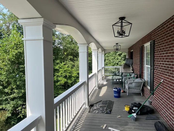 White porch columns, arches and railings on a two-story home