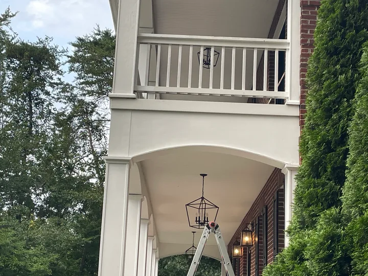 White porch columns, arches and railings on a two-story home