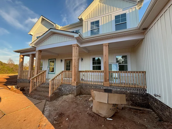 Home exterior with timber porch framing, columns and entry steps