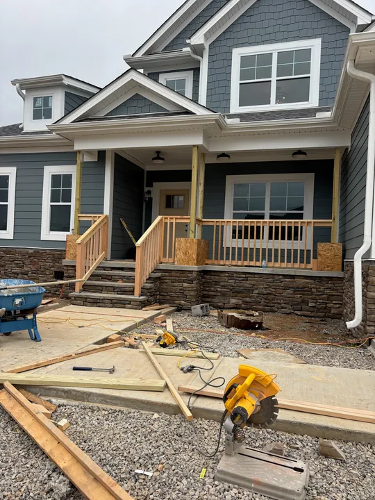 Home exterior with timber porch framing, columns and entry steps