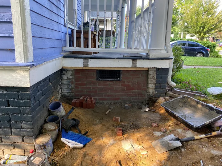 Masonry porch support and exposed repair area below a porch