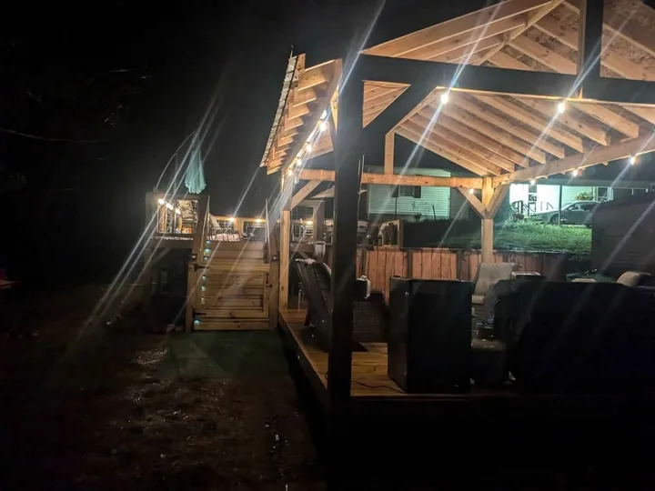 Covered timber porch with railings and warm evening lights