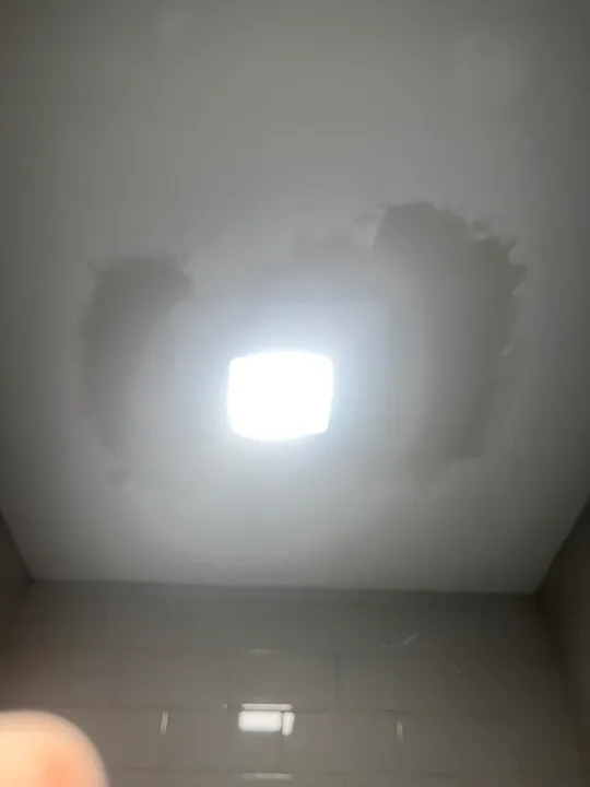 Recessed ceiling light and nearby painted ceiling surface