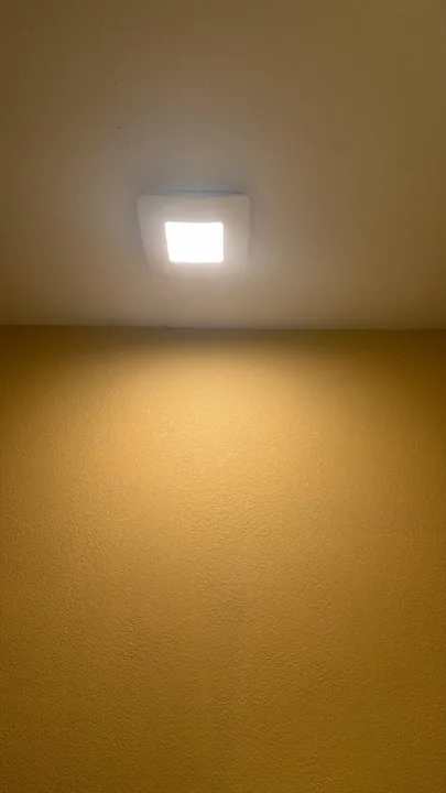 Recessed ceiling light and nearby painted ceiling surface