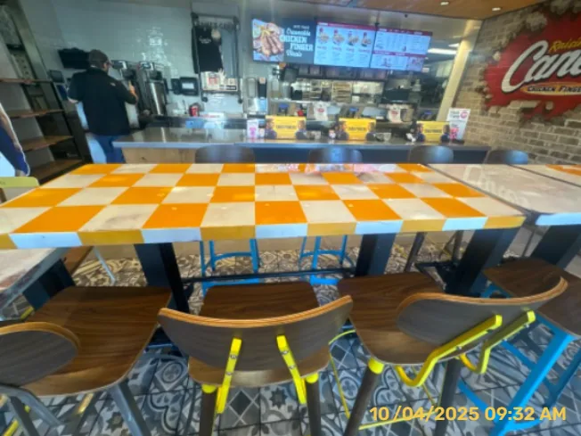 Restaurant tables with orange-and-white painted patterns and surface preparation