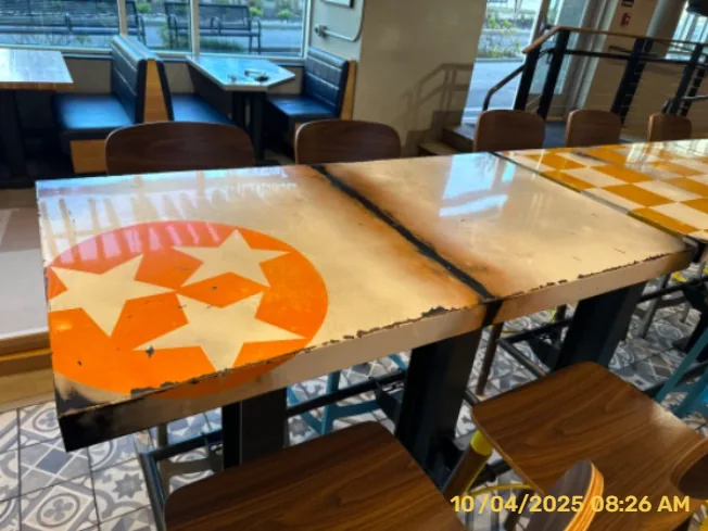 Restaurant tables with orange-and-white painted patterns and surface preparation