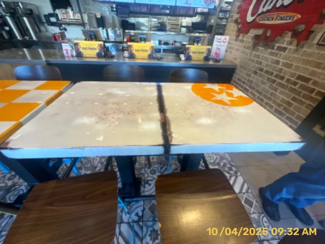Restaurant tables with orange-and-white painted patterns and surface preparation