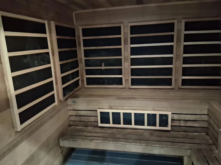 Timber benches, slatted walls and lower windows in a sauna