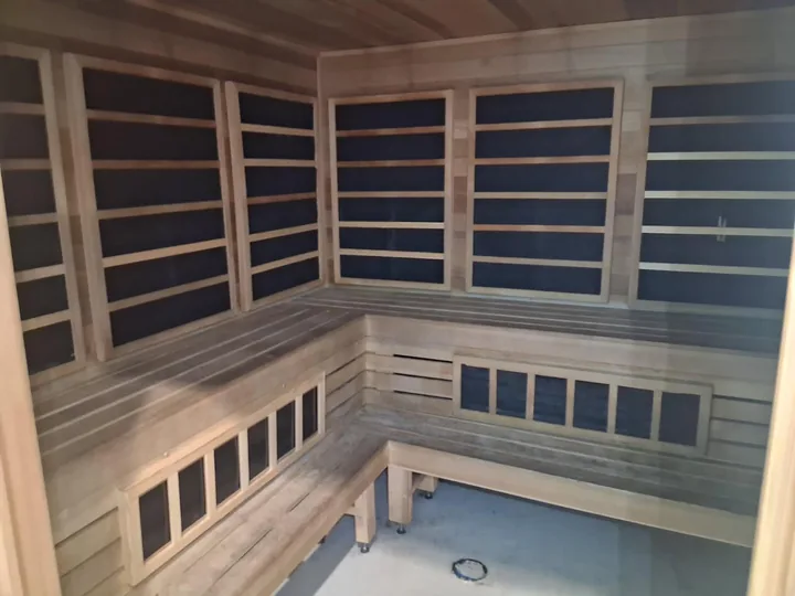 Timber benches, slatted walls and lower windows in a sauna