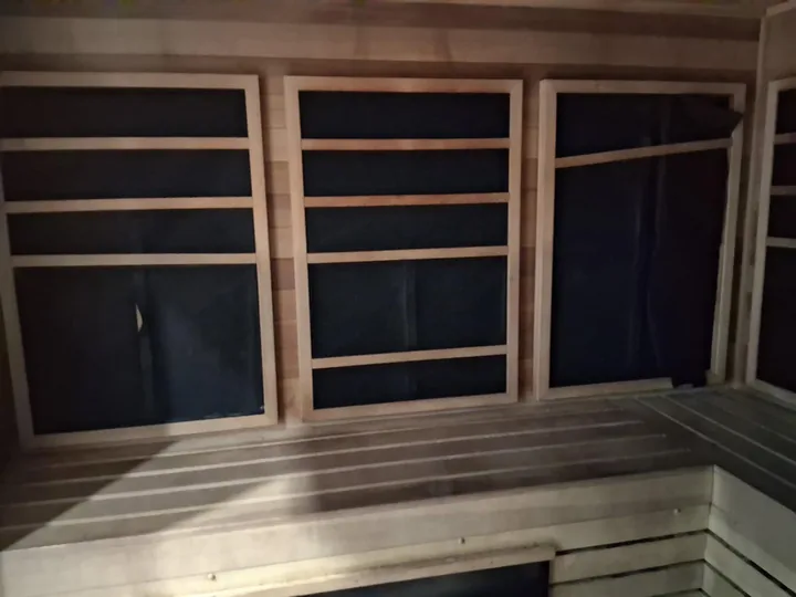 Timber benches, slatted walls and lower windows in a sauna