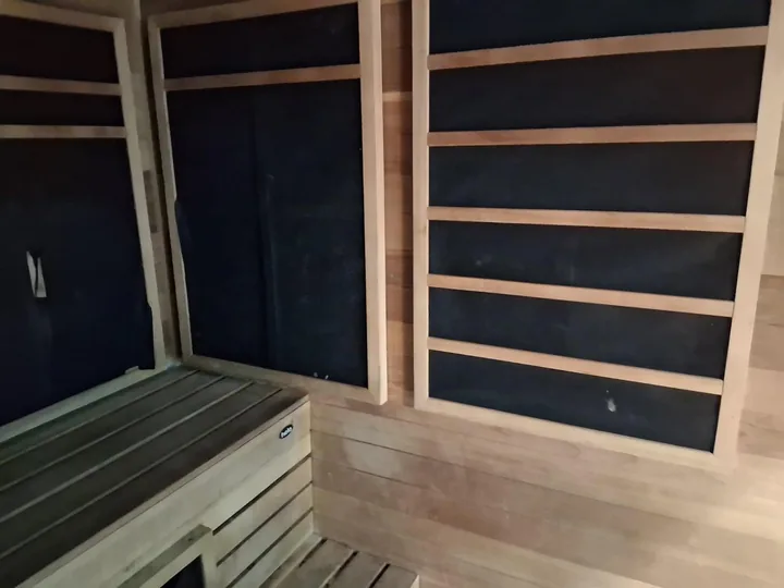 Timber benches, slatted walls and lower windows in a sauna
