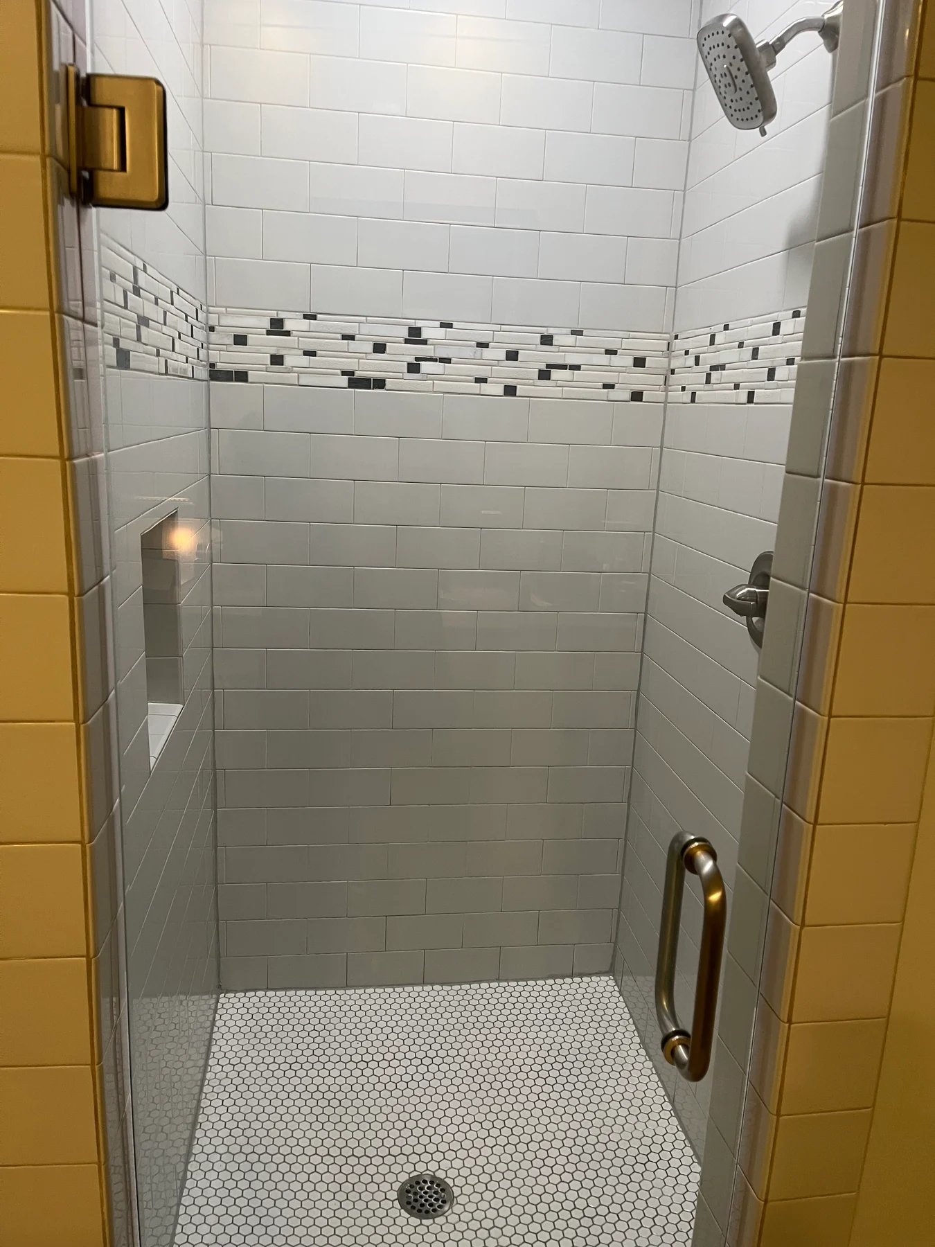 Tiled shower, patterned accent band and recessed shower light