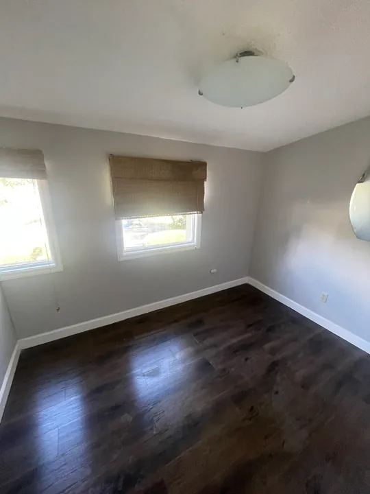Painted room, white trim and dark plank flooring after the room remodel