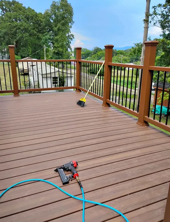 Stained deck boards and timber railings in a tree-lined yard