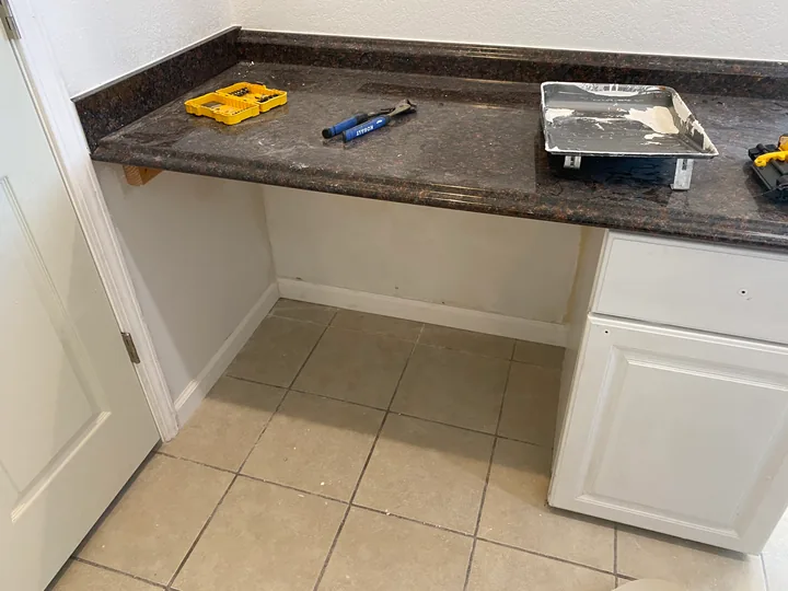 White storage shelves, built-in worktop and trim