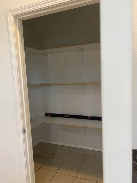 White storage shelves, built-in worktop and trim