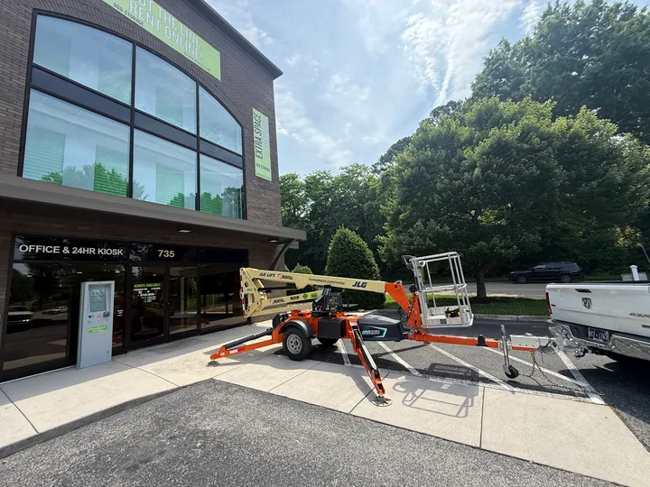 Extra Space Storage entrance with a boom lift and our work vehicles