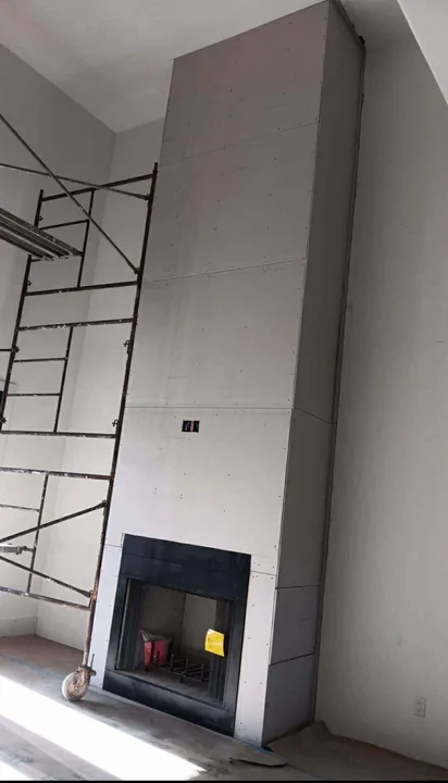 Tall tiled fireplace surround beside a doorway