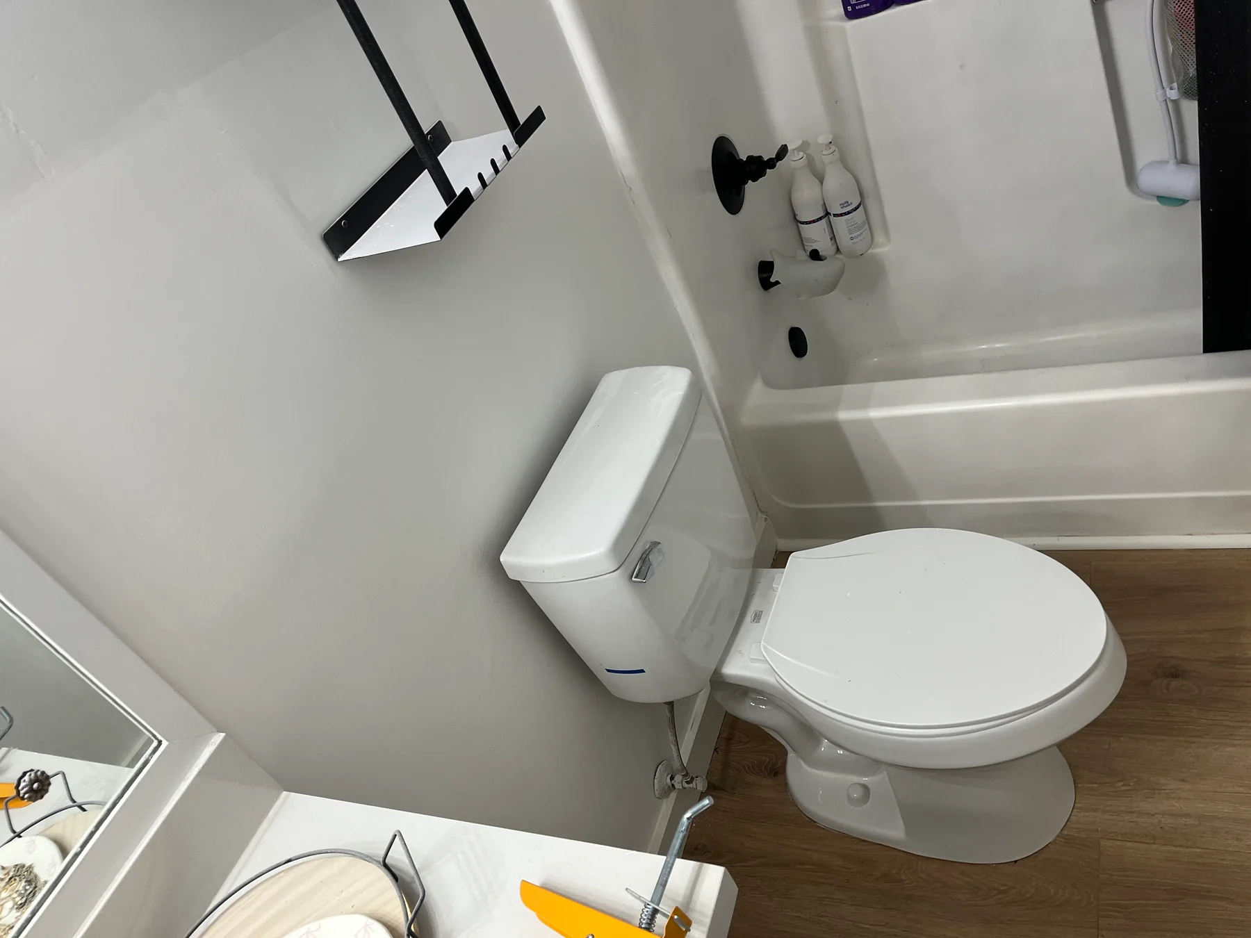 White toilet beside a bathroom vanity and tub