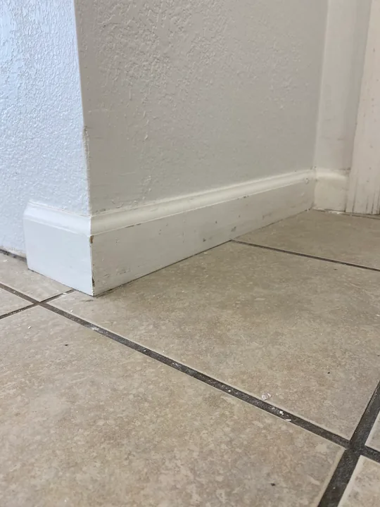 White baseboard, inside corners and wall-trim profiles