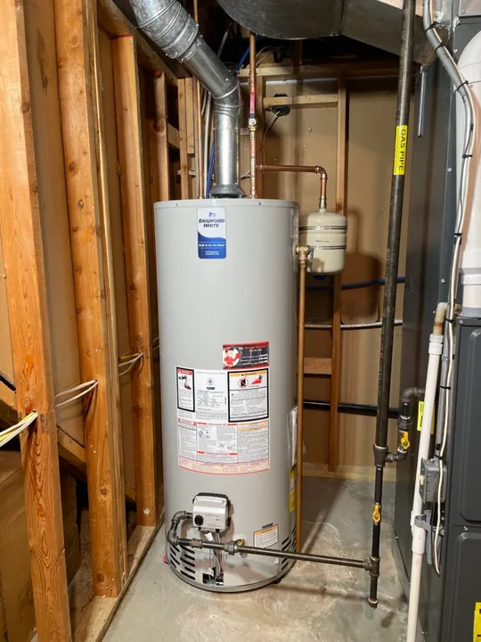 Water heater and supply pipes in a utility closet